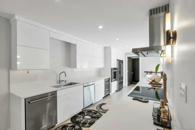 a kitchen with a sink appliances and cabinets