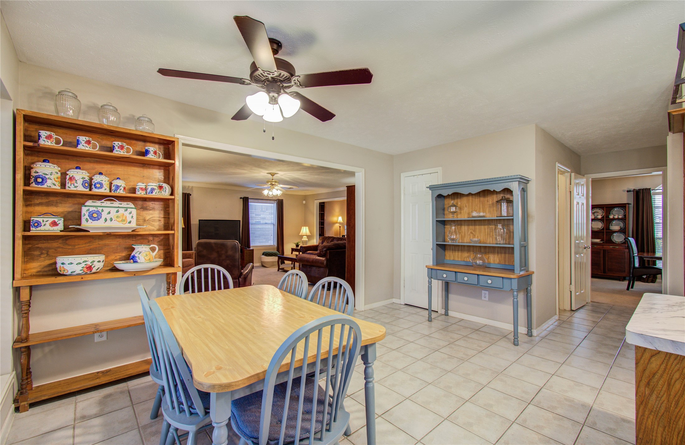 5927 Thom Road Humble, TX 77346 - Photo 11 of 50 The kitchen and breakfast area are filled with natural light and open seamlessly to the living room, offering lovely views of the back patio—perfect for gathering with family and friends.