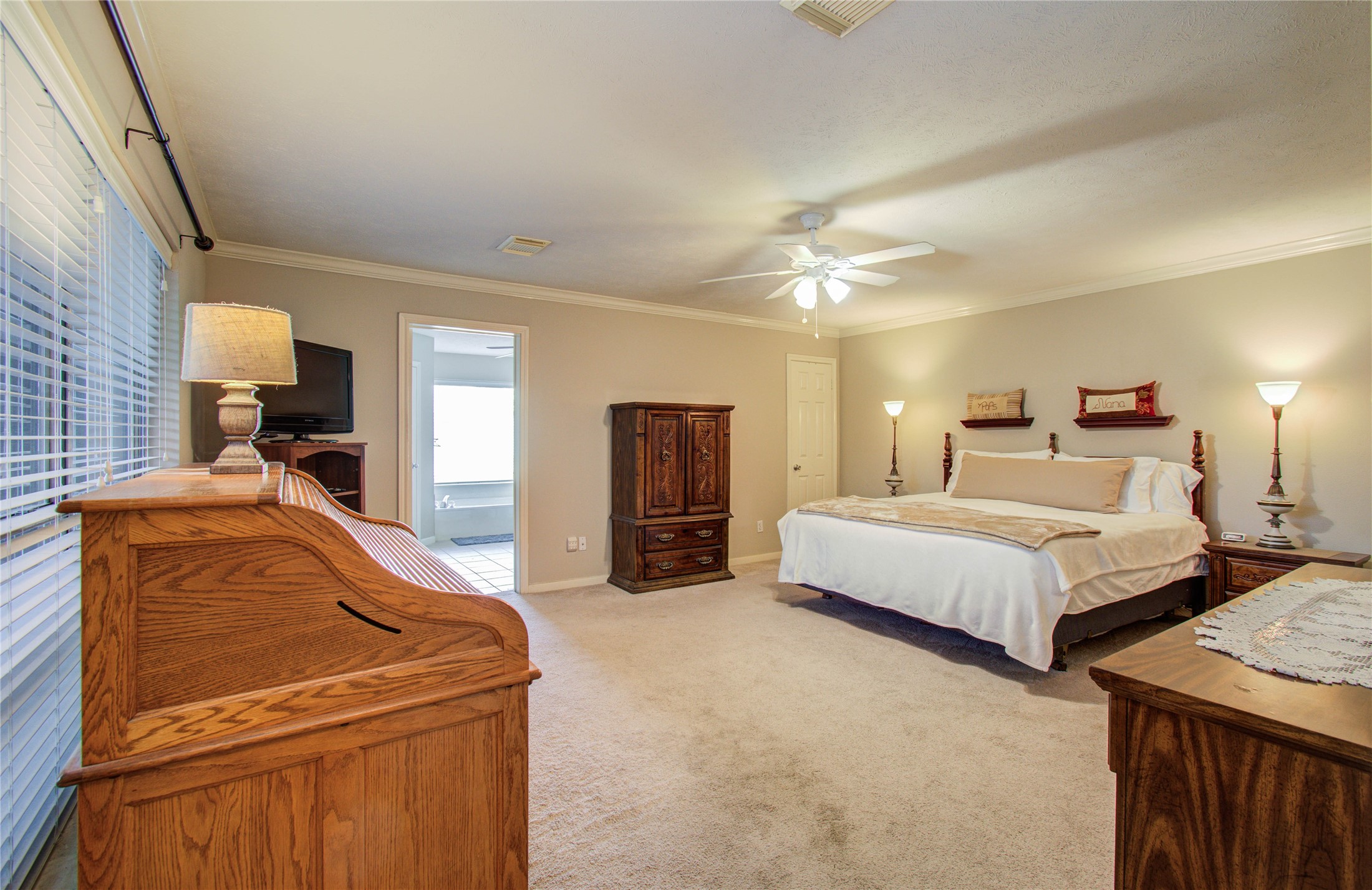5927 Thom Road Humble, TX 77346 - Photo 18 of 50 The first-floor primary suite is generously sized and filled with natural light, offering a private retreat.