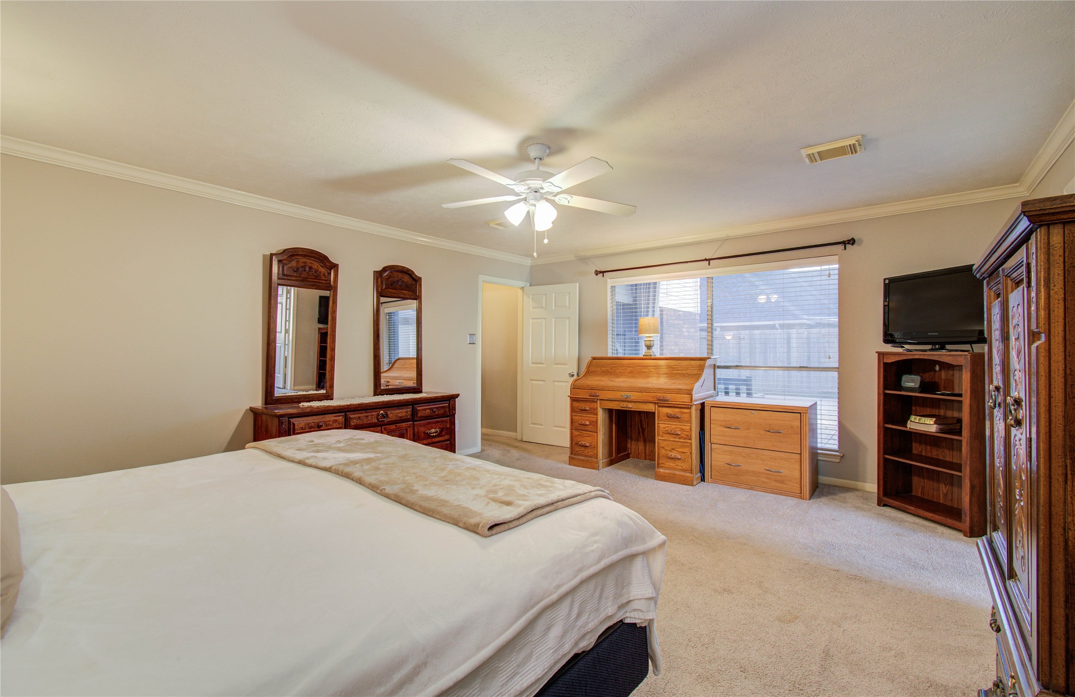 5927 Thom Road Humble, TX 77346 - Photo 20 of 50 The first-floor primary suite is generously sized and filled with natural light, offering a private retreat.