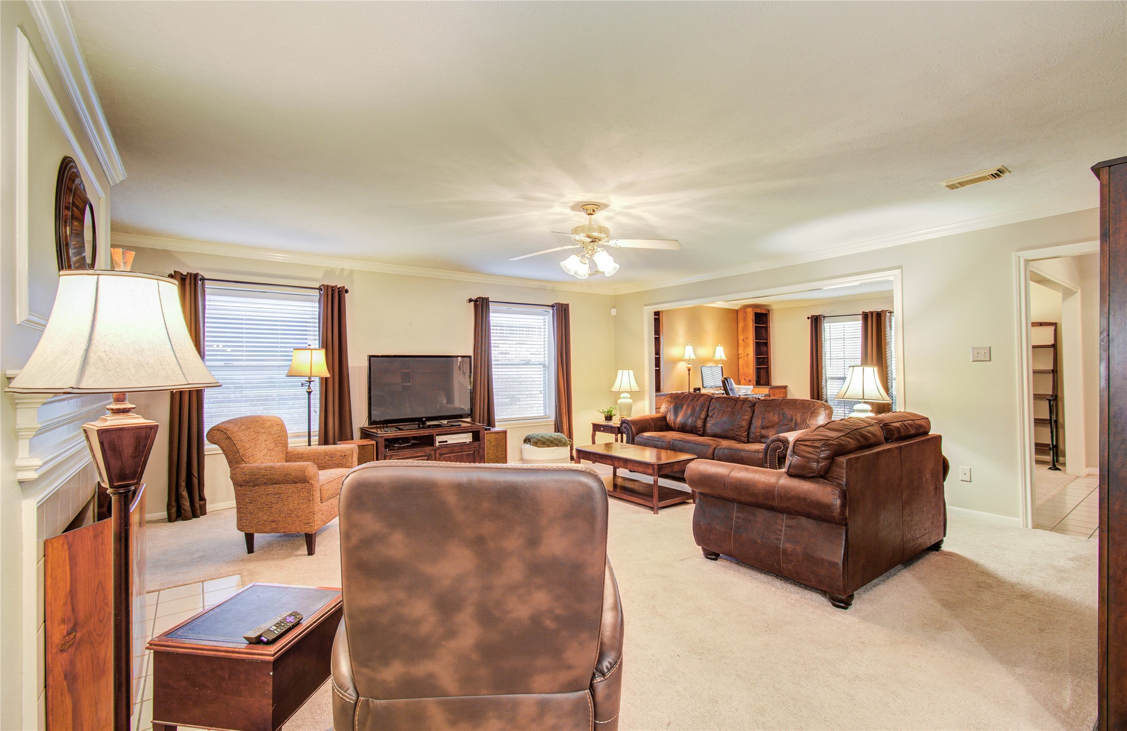 5927 Thom Road Humble, TX 77346 - Photo 23 of 50 The large living area includes built-in shelving and a fireplace, offering both functionality and a cozy ambiance.