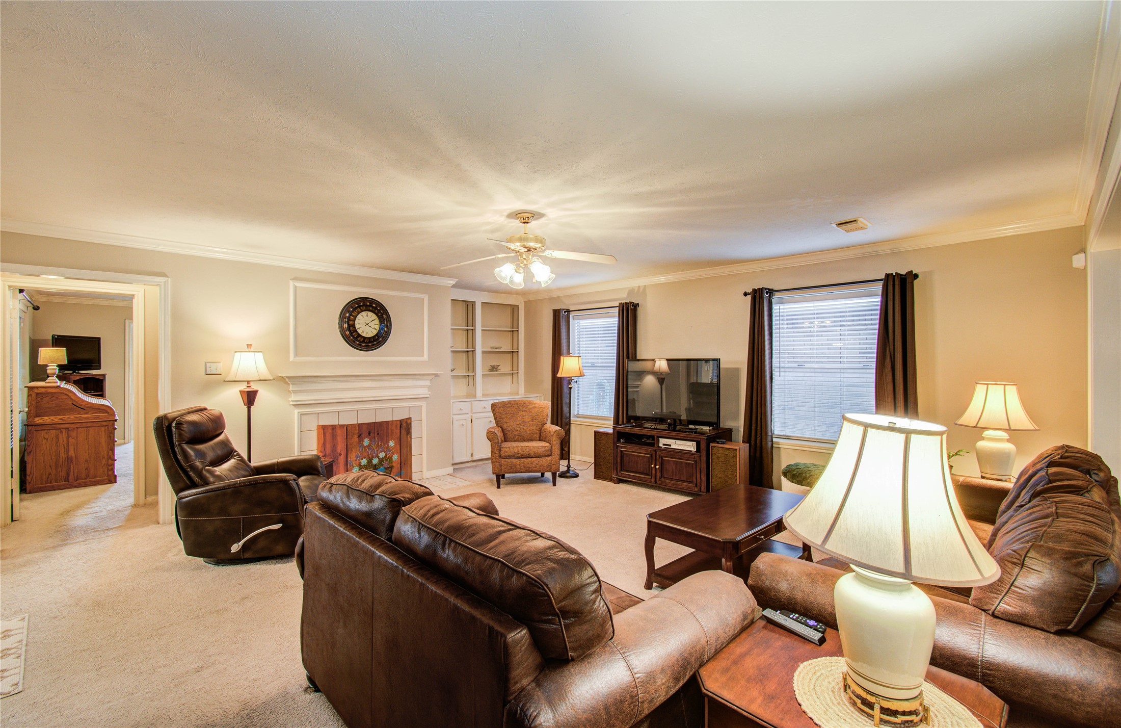 5927 Thom Road Humble, TX 77346 - Photo 25 of 50 The large living area includes built-in shelving and a fireplace, offering both functionality and a cozy ambiance.