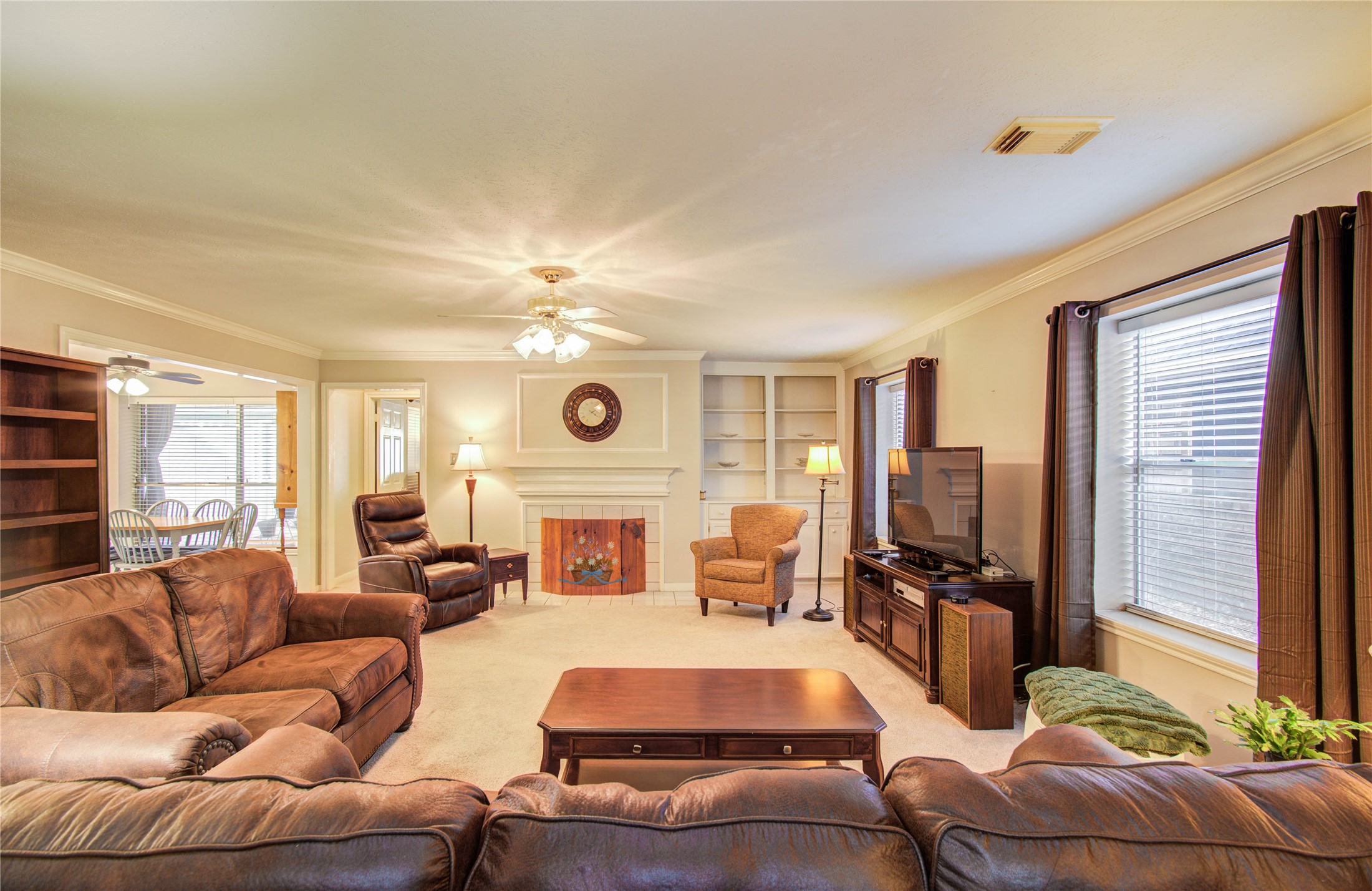 5927 Thom Road Humble, TX 77346 - Photo 26 of 50 The large living area includes built-in shelving and a fireplace, offering both functionality and a cozy ambiance.