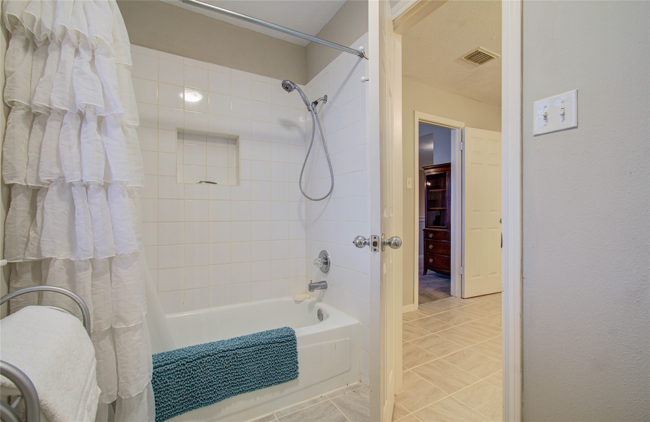 5927 Thom Road Humble, TX 77346 - Photo 33 of 50 A spacious upstairs bathroom includes plenty of cabinet space and a shower/tub combination.