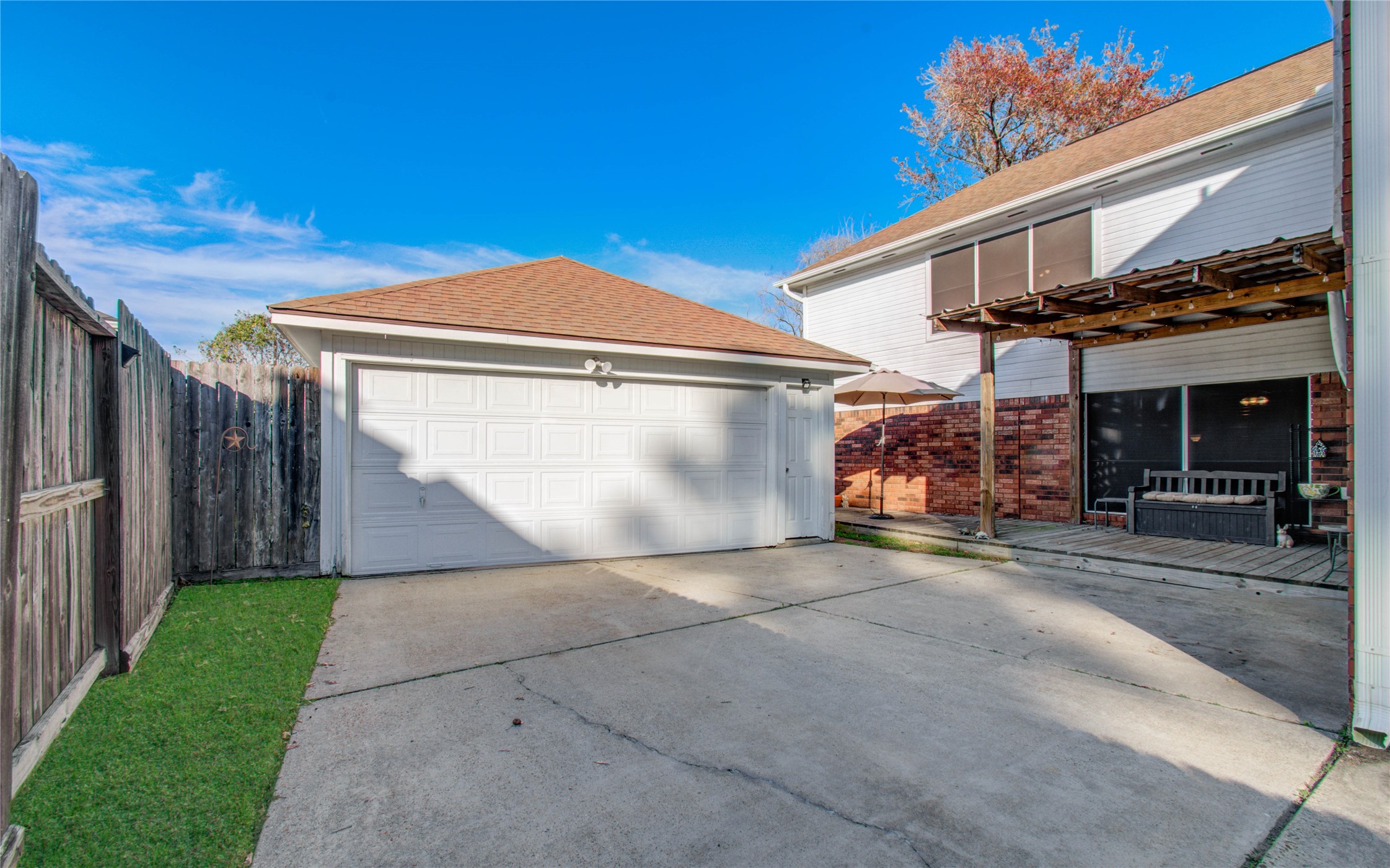 5927 Thom Road Humble, TX 77346 - Photo 46 of 50 The property includes a detached two-car garage and a covered patio, offering a perfect spot to unwind or enjoy your morning coffee.