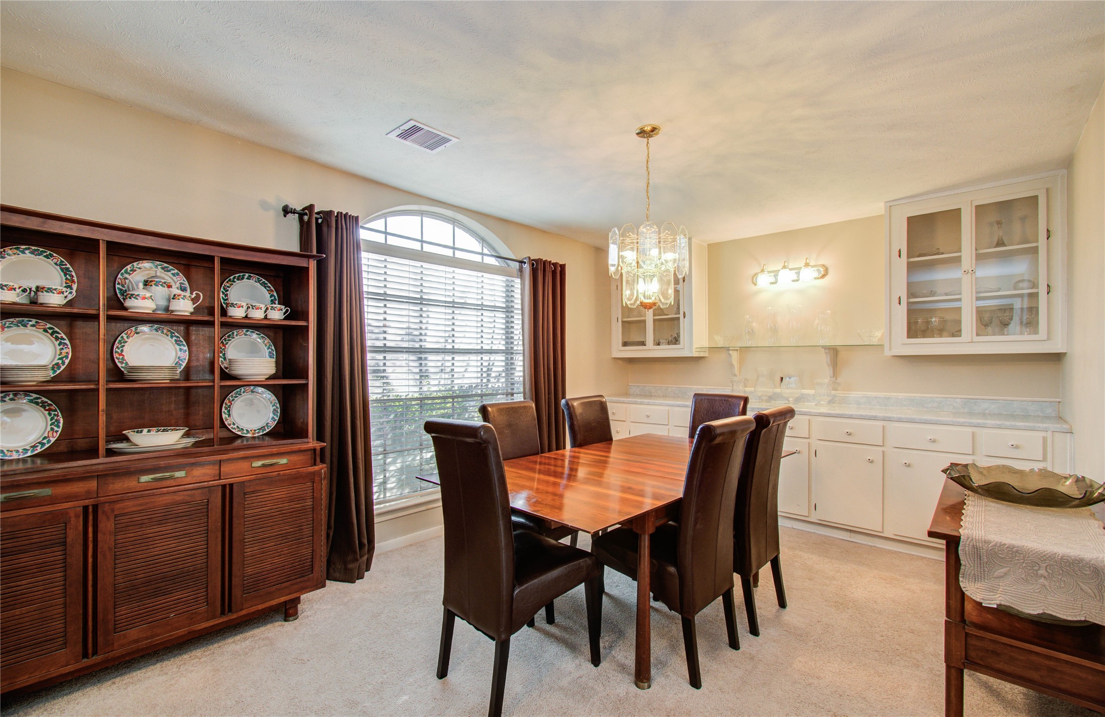 5927 Thom Road Humble, TX 77346 - Photo 7 of 50 The formal dining room offers abundant natural light and custom built-ins, creating an inviting space for gatherings.