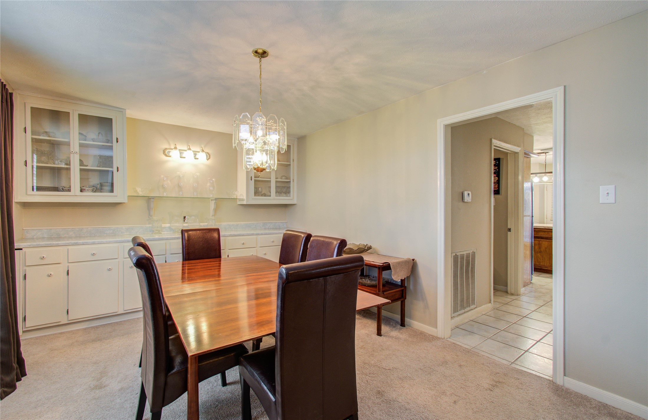 5927 Thom Road Humble, TX 77346 - Photo 8 of 50 The formal dining room offers abundant natural light and custom built-ins, creating an inviting space for gatherings.