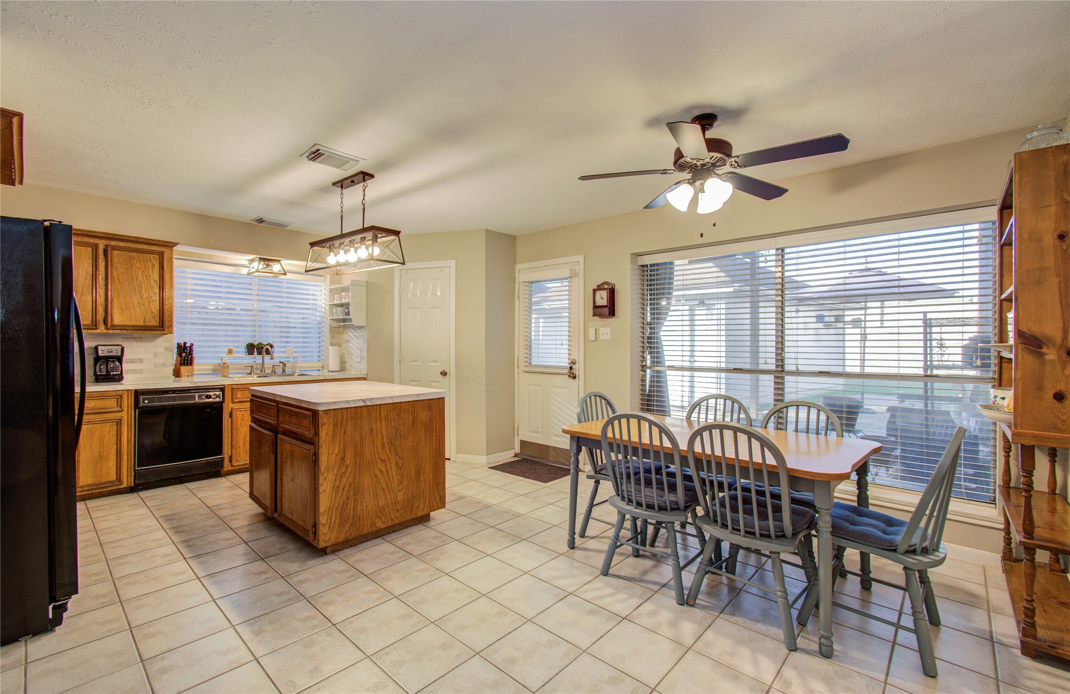 5927 Thom Road Humble, TX 77346 - Photo 9 of 50 The kitchen and breakfast area are filled with natural light and open seamlessly to the living room, offering lovely views of the back patio—perfect for gathering with family and friends.