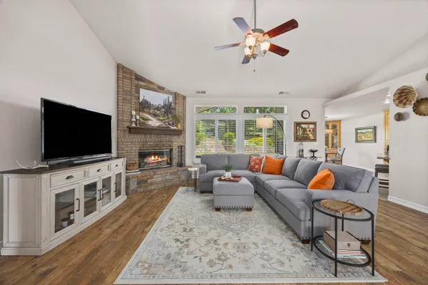 a living room with furniture a window and a fireplace