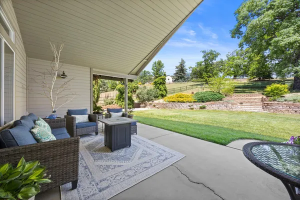 a view of a patio with couches chairs and a big yard