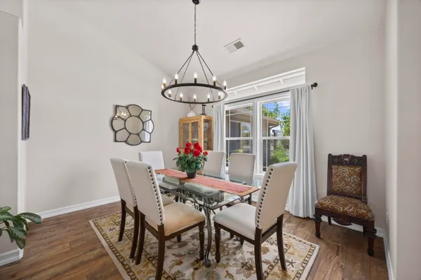 a dining room with furniture and window