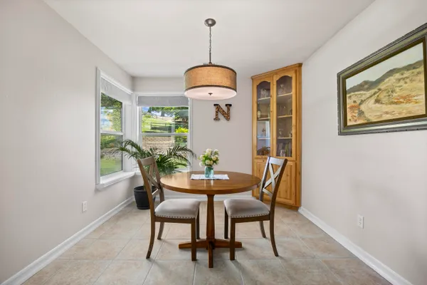a dining room with furniture and window