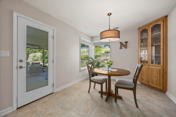 a kitchen with granite countertop cabinets stainless steel appliances a sink and a refrigerator