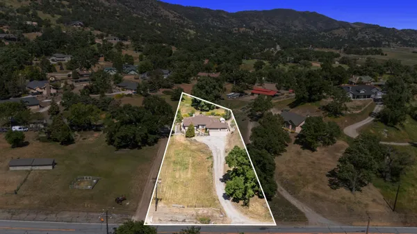 an aerial view of house with yard