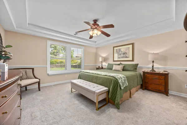 a bedroom with a bed dresser and a window