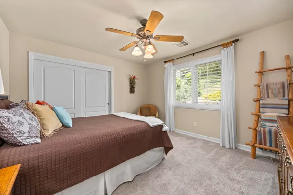 a bedroom with a bed and a couch