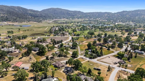 an aerial view of residential house with outdoor space and mountain view