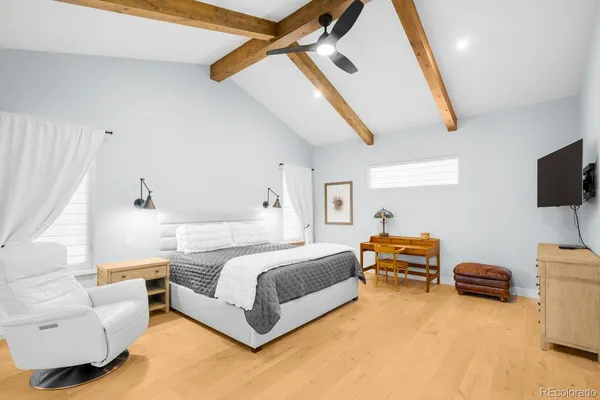 a spacious bedroom with a bed and a window