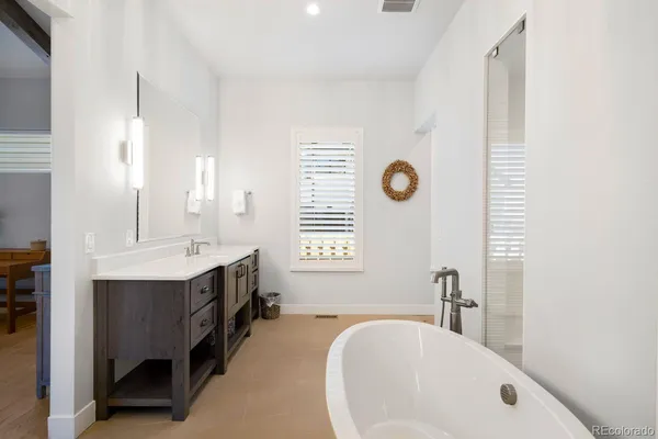 a bathroom with a white tub and shower