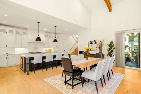 a dining room with furniture and wooden floor