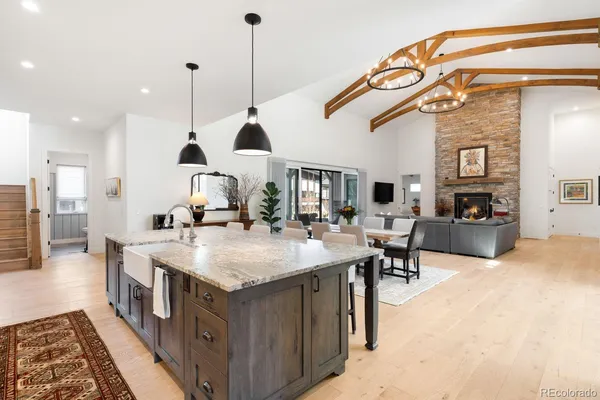 a kitchen with stainless steel appliances granite countertop a sink a stove and a refrigerator