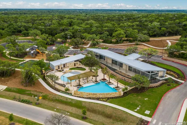 an aerial view of a house with a garden and swimming pool