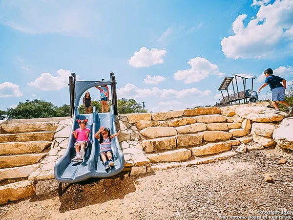 a view of a backyard with plants and outdoor seating