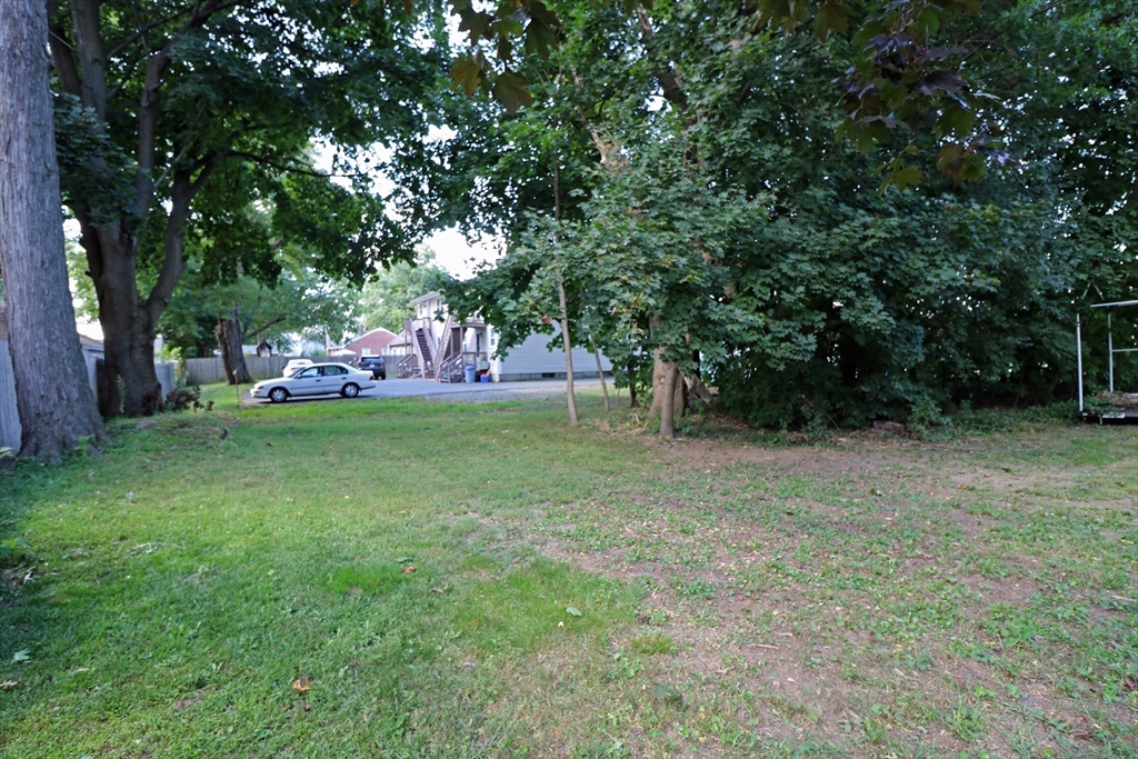 184 Howard Street Ludlow, MA 01056 - Photo 2 of 18 a view of a trees in a yard