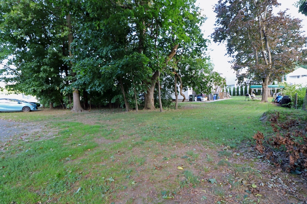 184 Howard Street Ludlow, MA 01056 - Photo 5 of 18 a view of green field with trees in the background