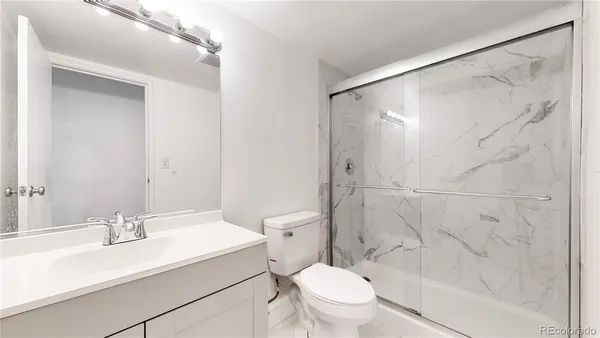 a bathroom with a sink toilet and shower