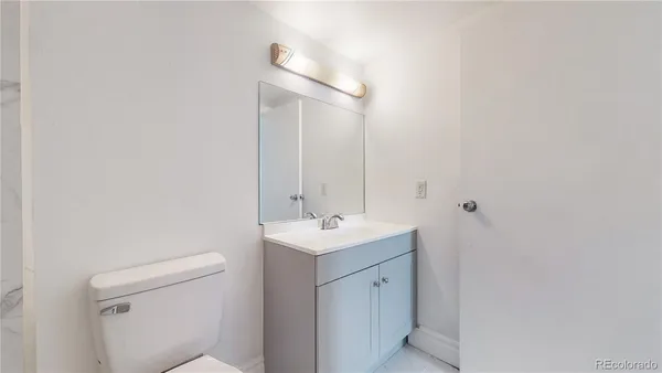 a bathroom with a sink a toilet and mirror