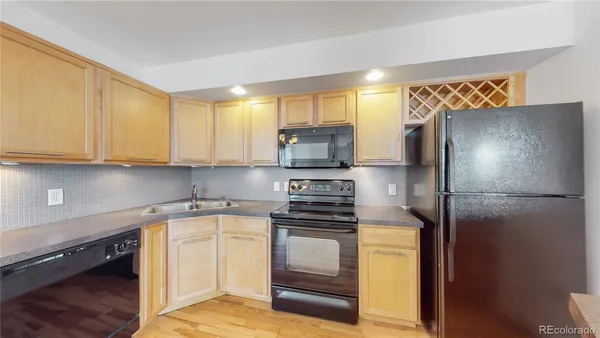 a kitchen with a refrigerator sink and cabinets