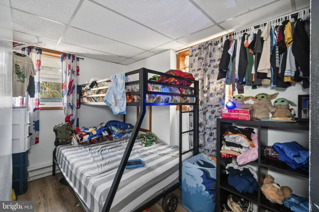 a view of empty room with wooden floor and windows