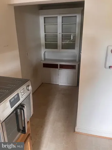 a view of road with card parked on the roadside