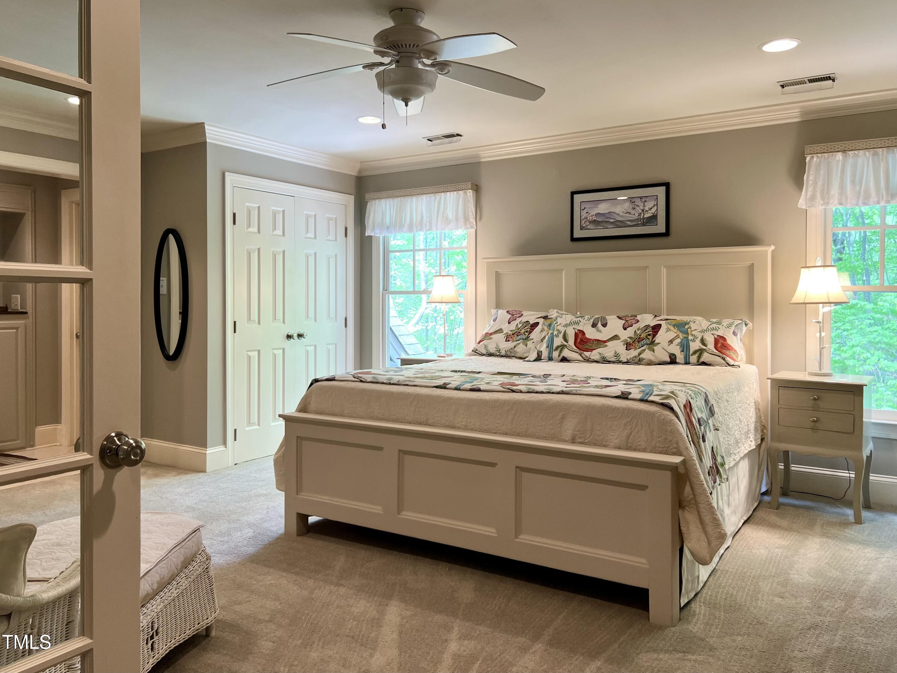 1425 Bascomb Drive Raleigh, NC 27614 - Photo 20 of 51 a bedroom with a bed and a chandelier