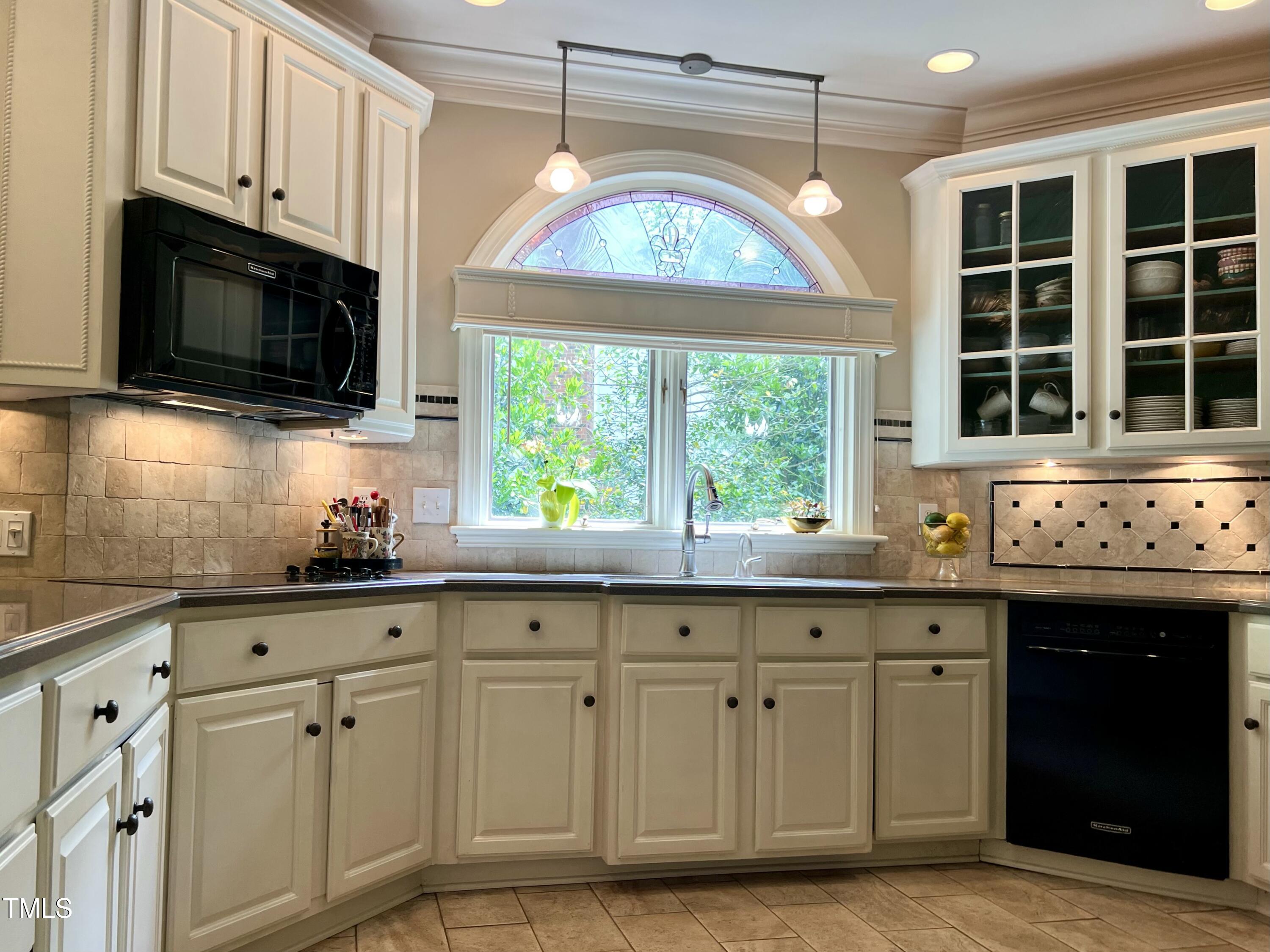 1425 Bascomb Drive Raleigh, NC 27614 - Photo 9 of 51 a kitchen with white cabinets a sink and a stove