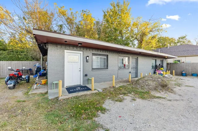 a view of a house with a patio and a yard