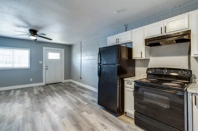 a kitchen with a stove and a refrigerator