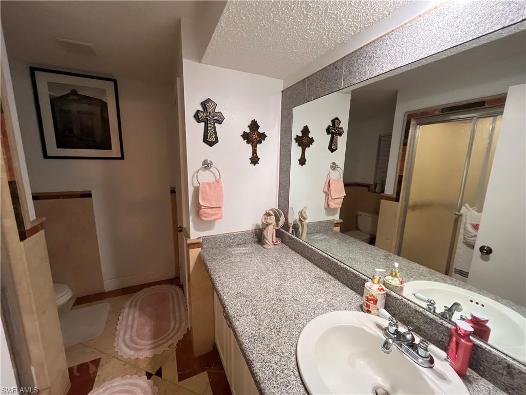 5000 17th Avenue Southwest Naples, FL 34116 - Photo 14 of 20 a bathroom with a granite countertop sink and a mirror