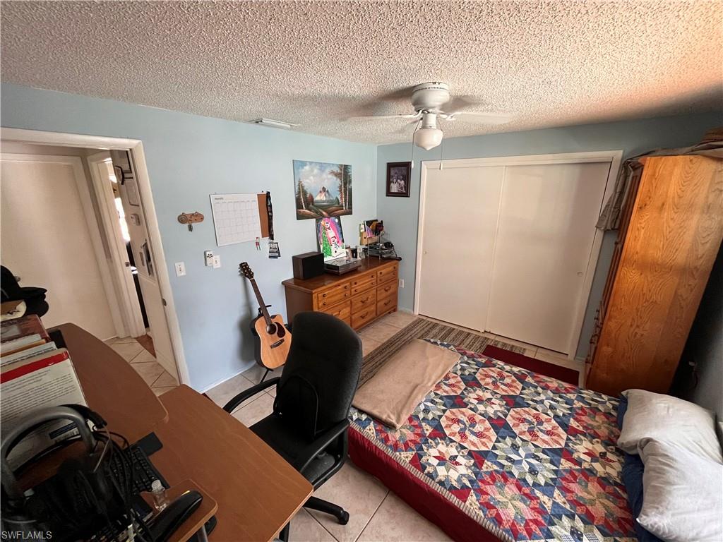 5000 17th Avenue Southwest Naples, FL 34116 - Photo 15 of 20 a bedroom with furniture and a window