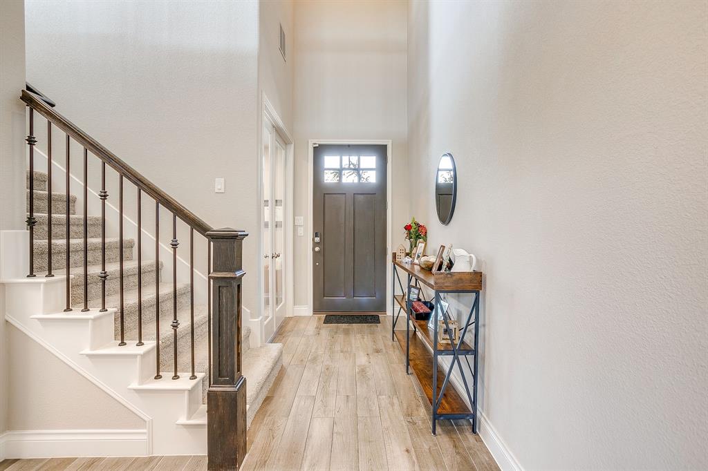 5709 Pope Creek Road Fort Worth, TX 76126 - Photo 5 of 39 Step inside to a light-filled interior featuring beautiful wood-look tile flooring throughout the main living areas.