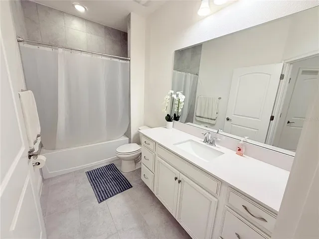a bathroom with a double vanity sink toilet and shower