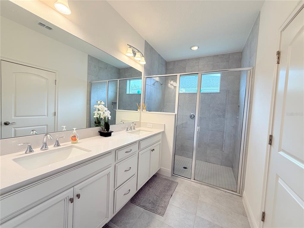 3112 Oxbow Court Harmony, FL 34773 - Photo 13 of 22 a spacious bathroom with a shower sink and mirror