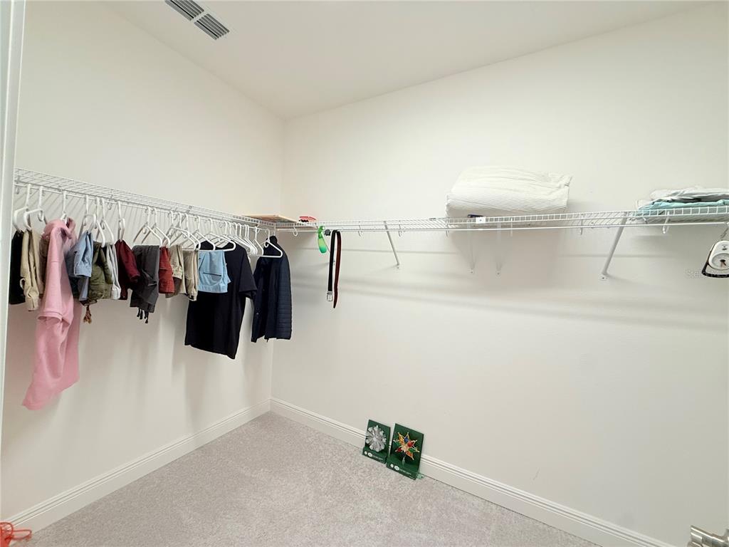3112 Oxbow Court Harmony, FL 34773 - Photo 15 of 22 a view of walk in closet with clothes and shoes