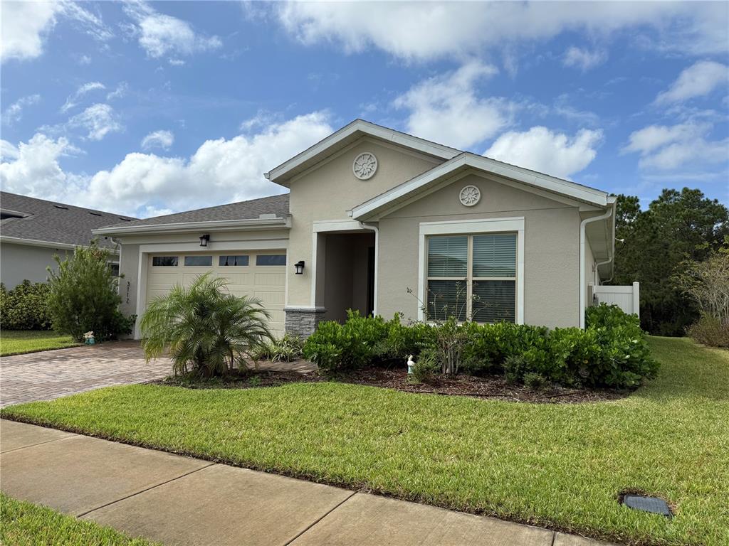 3112 Oxbow Court Harmony, FL 34773 - Photo 2 of 22 a front view of house with yard and green space