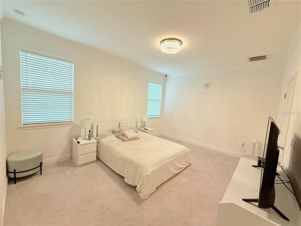 3112 Oxbow Court Harmony, FL 34773 - Photo 7 of 22 a room with a bed and a desk