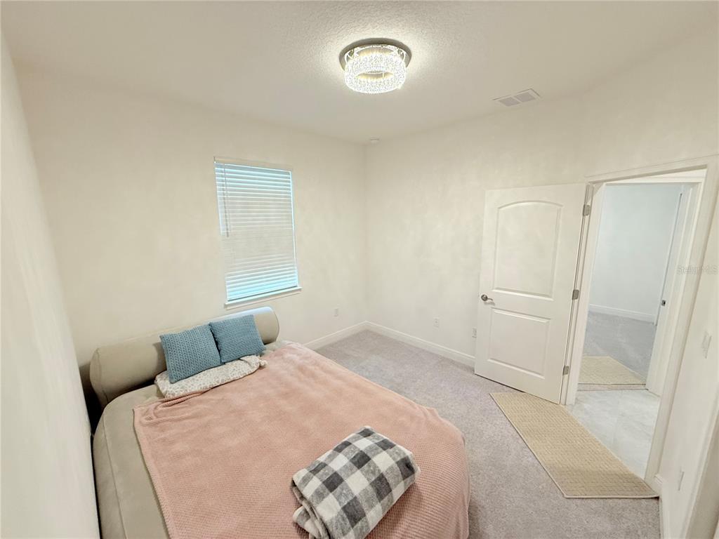 3112 Oxbow Court Harmony, FL 34773 - Photo 10 of 22 a bedroom with a bed and a window