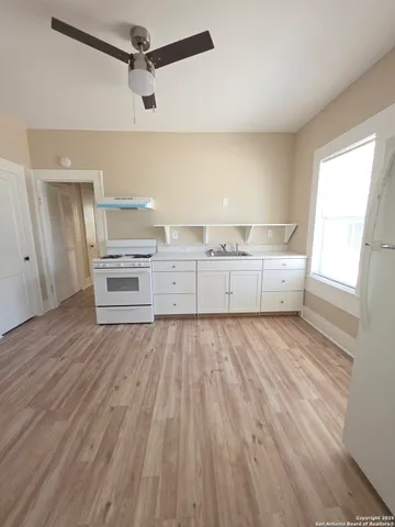 a view of a room with wooden floor and cabinet
