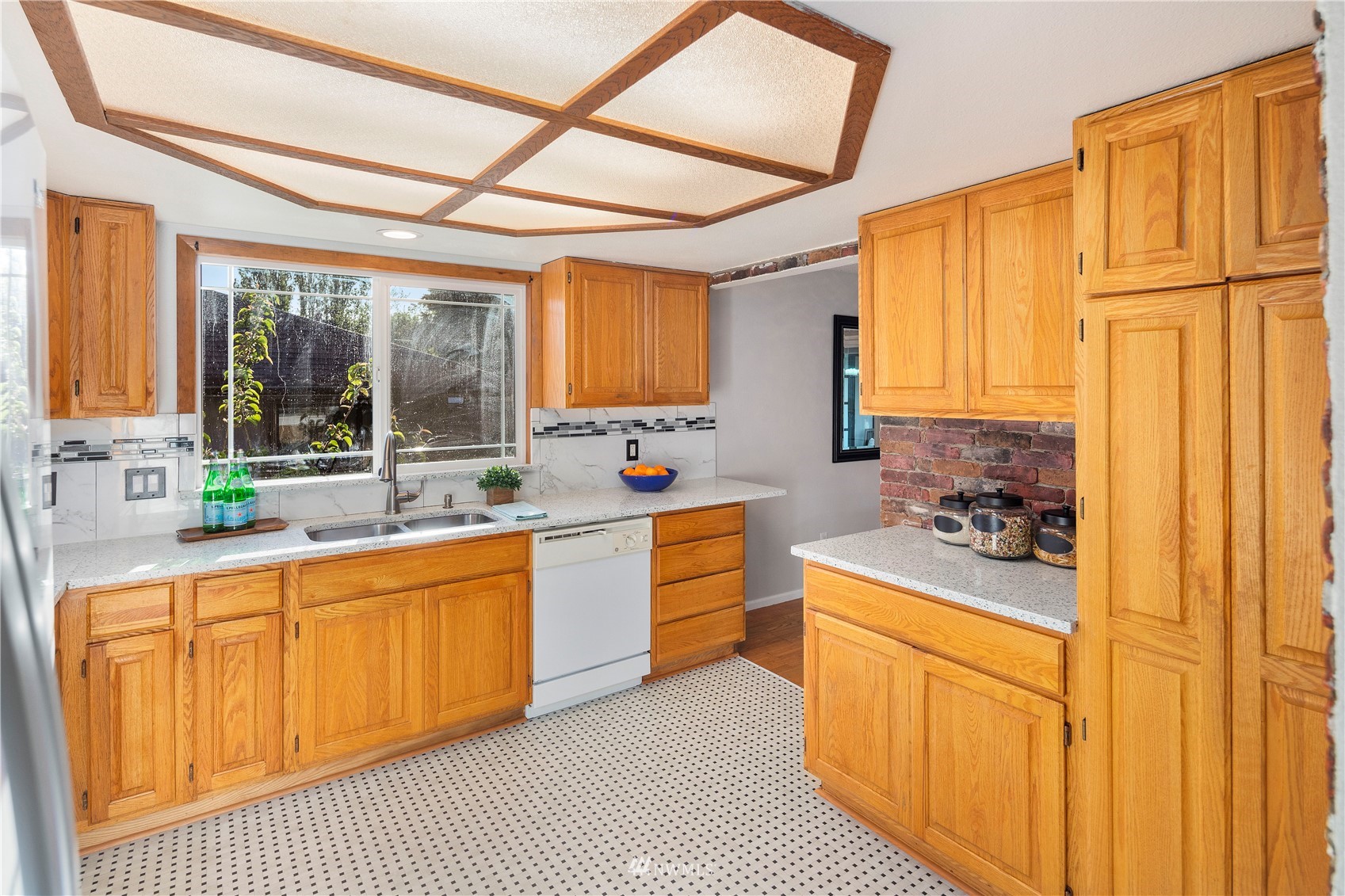 4800 South Frontenac Street Seattle, WA 98118 - Photo 11 of 40 a large white kitchen with stainless steel appliances granite countertop a sink and cabinets