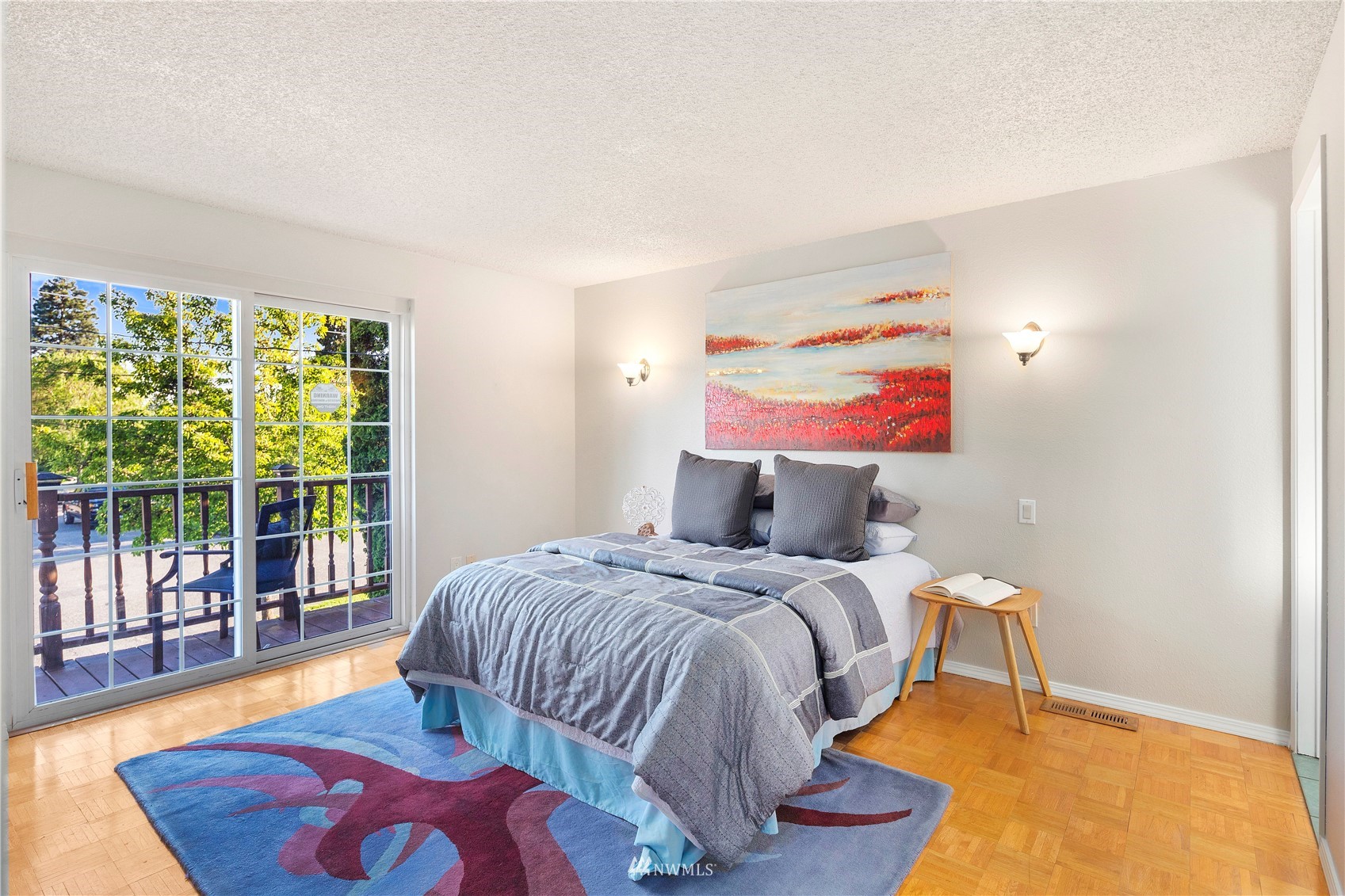 4800 South Frontenac Street Seattle, WA 98118 - Photo 16 of 40 a bedroom with a bed and wooden floor